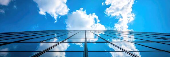Low angle view of skyscraper with glass windows and blue sky background for business, trade and finance concept photo