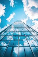 Low angle view of skyscraper with glass windows and blue sky background for business, trade and finance concept photo