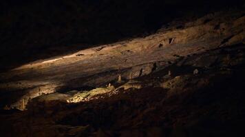 Exploring the shadows combined with rich textures in an enchanting dark cave scene video