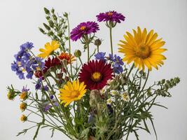 A vivid bouquet of colorful wildflowers stands gracefully against a plain background photo