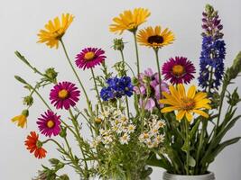 An elegant arrangement of vibrant wildflowers captured against a simple white background photo