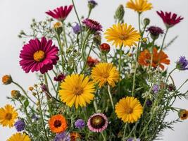 A vibrant bouquet of assorted flowers in full bloom against a white background photo