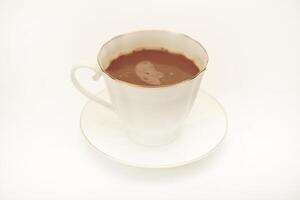 A white cup and saucer with coffee on a white background. photo