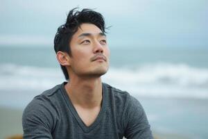 Man practicing mindful breathing on a secluded beach photo