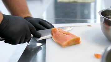 peel salmon Close up of chef peeling salmon fillet on wooden board in kitchen - Descale Skin From Salmon Fillet With A Sharp Knife video