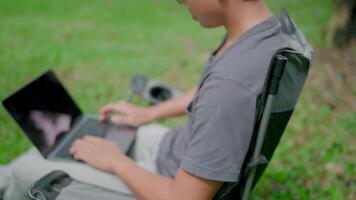 Programmer busy work hard developing new software writing program code on a laptop. Work stress, stiff neck relief pain ache, suffer burnout brownout office syndrome, anxiety, working in a park. video