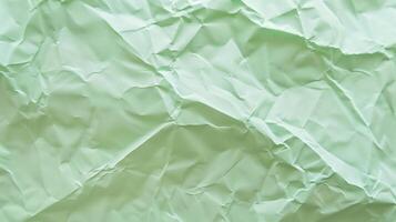 Close-up of wrinkled green paper texture, ideal for scrapbooking and crafting. Top view photo