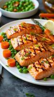 Grilled salmon with asparagus, peas, carrots, on a white platter. Healthy food. Restaurant menu photo