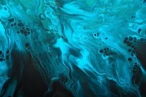 Fluid Art. Blue abstract wave swirls on black background. Marble effect background or texture photo