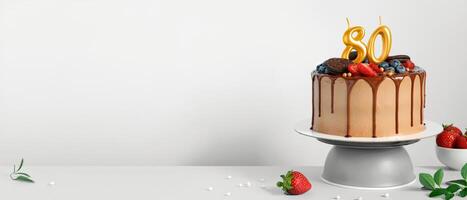 Banner with Chocolate birthday cake with berries, cookies and number eighty golden candles on White background, copy space photo