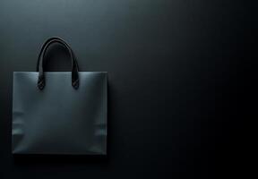 A black background with a subtle texture and the shadow of a shopping bag, leaving plenty of room for copy space photo