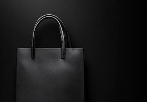 A black background with a subtle texture and the shadow of a shopping bag, leaving plenty of room for copy space photo