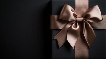 A black background with a ribbon bow elegantly tied and placed in the upper corner, creating a luxurious gift feel with empty space photo