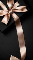 A black background with a ribbon bow elegantly tied and placed in the upper corner, creating a luxurious gift feel with empty space photo