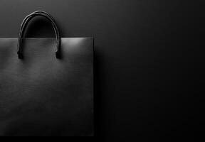 A black background with a subtle texture and the shadow of a shopping bag, leaving plenty of room for copy space photo