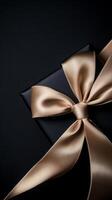 A black background with a ribbon bow elegantly tied and placed in the upper corner, creating a luxurious gift feel with empty space photo