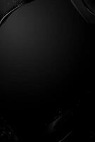 A black background with a faint shine and the hint of luxury products in the corners, perfect for adding advertising text photo