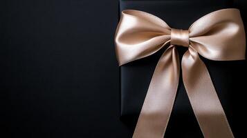 A black background with a ribbon bow elegantly tied and placed in the upper corner, creating a luxurious gift feel with empty space photo