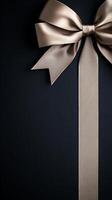 A black background with a ribbon bow elegantly tied and placed in the upper corner, creating a luxurious gift feel with empty space photo