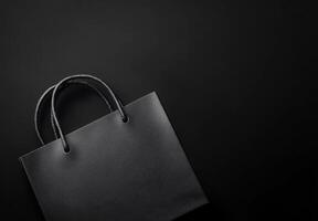 A black background with a subtle texture and the shadow of a shopping bag, leaving plenty of room for copy space photo