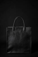 A black background with a subtle texture and the shadow of a shopping bag, leaving plenty of room for copy space photo