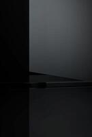 A glossy black background with a hint of a product display shelf in the corner, perfect for adding text to the empty space photo
