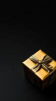 A sleek black background with a gold-wrapped gift box placed subtly in one corner, leaving the rest of the space empty for text photo