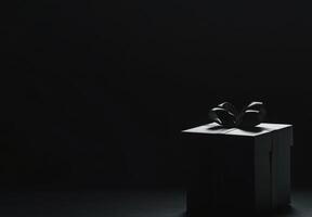 A black background with the silhouette of a gift box slightly off-center, ideal for promotional banners with copy space photo