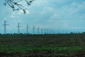 High voltage towers with sky background. Power line support with wires for electricity transmission. High voltage grid tower with wire cable at distribution station. Energy industry, energy saving photo