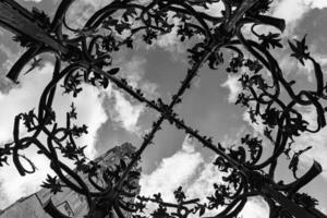 Black and white view from the water well on the cloudy sky and ancient cathedral photo