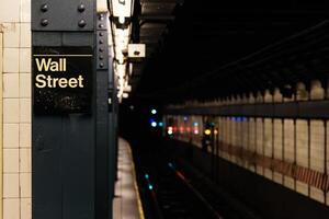 Wall street sign in empty subway photo