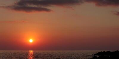 Sky sunset sunset and clouds. Bright red and gold twilight background. Sky and sea picture photo