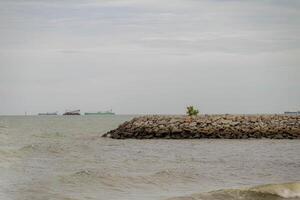 The breathtaking Pengkalan Balak beach in Malaysia is a beautiful stretch of coastline with powdery natural sand, bright sea waters, and serene surroundings that provide a sense of pure bliss. photo
