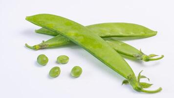 a pile of green peas on a white background photo