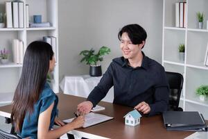Real estate agent assisting a client in signing a contract photo
