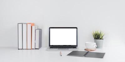 Minimalist Workspace with Laptop and Books on Desk photo