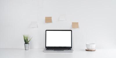 Simple Workspace with Laptop and Coffee Cup on Desk photo