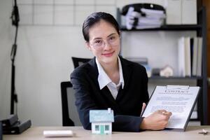 Real Estate Agent Presenting Contract to Client for Signature photo