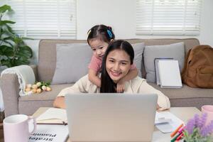 Mother and Child Sharing a Warm Moment with Laptop photo