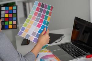 Graphic designer reviewing color palette for creative project photo