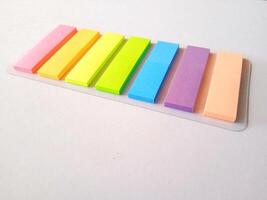 Note sticks in various colors isolated on white photo
