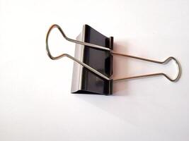 Black paperclip on a white background photo