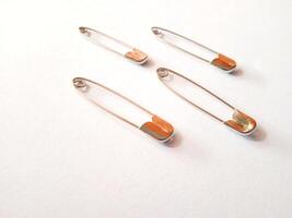 safety pins on a white background photo