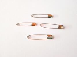 safety pins on a white background photo