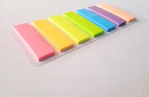 Note sticks in various colors isolated on white photo