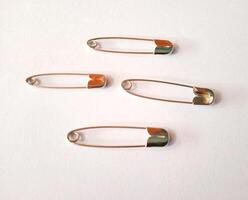 safety pins on a white background photo