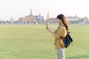 Traveler asian woman in her 30s explores the Grand Palace complex. This photo embodies the fascination with Thai culture and heritage.