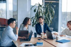 Creative business team working on project in modern office with panoramic view photo
