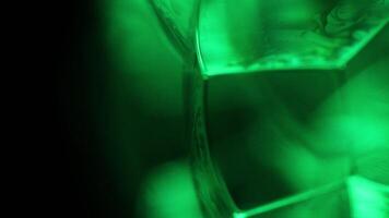 Green liquid, bubble in macro, movement of liquid in a bubble, vertical view, bright background video