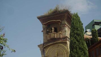 Medieval-style angel figurine appears at the top of the clock tower and, due to the operation of the clockwork mechanism, begins to strike the bell, alerting the townspeople to the time. video